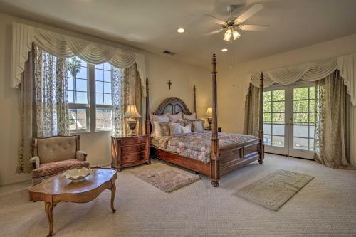 ein Schlafzimmer mit einem Bett und einem Stuhl und Fenstern in der Unterkunft El Cajon Home with Pool, Grill Station and Decks in El Cajon