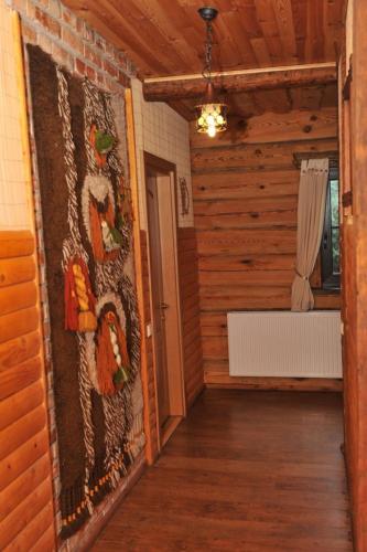 a hallway of a house with a wall of wood at Kurėnų Užeigos Svečių Namai in Kurėnai
