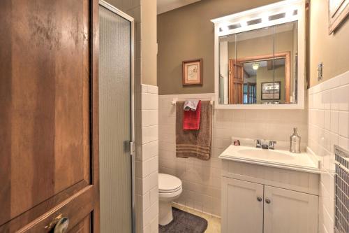 a bathroom with a sink and a toilet and a mirror at Spacious Home 2 Mi from Downtown Stanford! in Stanford