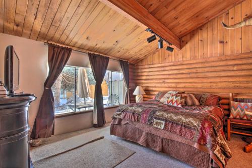 a bedroom with a bed and a large window at Walk to Lava Hot Springs Pools from Cozy Cabin! in Lava Hot Springs