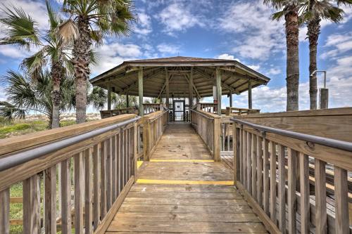 a wooden boardwalk leading to a pavilion with palm trees at Beachside St Augustine Resort Condo, 6 Mi to Dtwn! in Coquina Gables