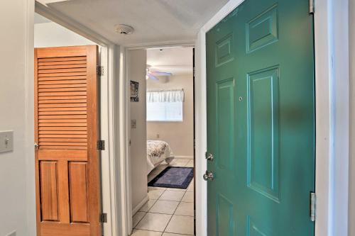 a green door leading to a hallway with a bedroom at Waterfront Middle Bass Condo with Pool Access! in Put-in-Bay
