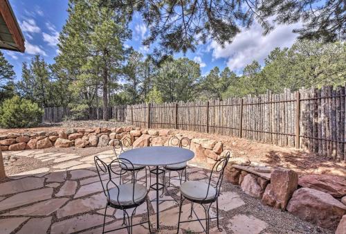 a patio with a table and chairs and a fence at Artists Retreat with Pecos National Park Views! in Rowe