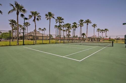 a tennis court with palm trees in the background at Condo on Golf Course - 10 Mi to South Padre Island in Laguna Vista