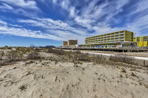 a view of a beach with a yellow building at Coastal Condo with Pool, 1 Block to Wildwood Beach! in Wildwood