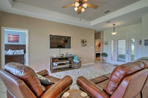 a living room with leather furniture and a flat screen tv at Condo on Golf Course - 10 Mi to South Padre Island in Laguna Vista