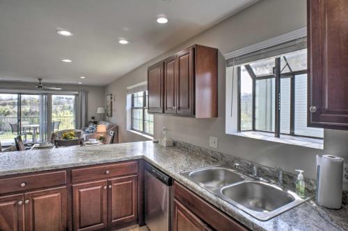 a kitchen with wooden cabinets and a sink at Less Than 1 Mi to Branson Strip Condo on Golf Course! in Branson