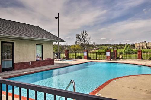 a swimming pool with a fence next to a house at Sevierville Resort Retreat about 2 Mi to Pigeon Forge! in Pigeon Forge