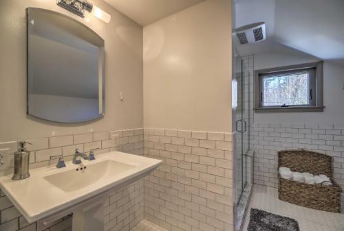 a white bathroom with a sink and a mirror at Plattsburgh Home with Deck on Lake Champlain in Plattsburgh