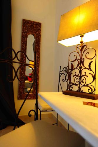 a lamp sitting on a table next to a mirror at La Civetta in Foggia