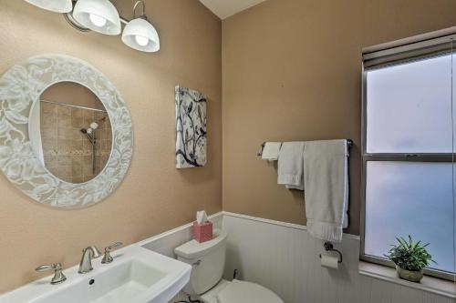 a bathroom with a sink and a toilet and a mirror at Tucson Getaway with Yard, Pool, Hot Tub and Gas Grill! in Tucson