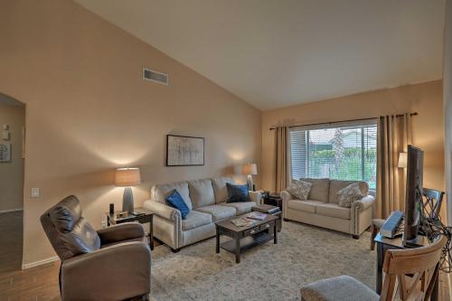 a living room with a couch and a tv at Tucson Getaway with Yard, Pool, Hot Tub and Gas Grill! in Tucson