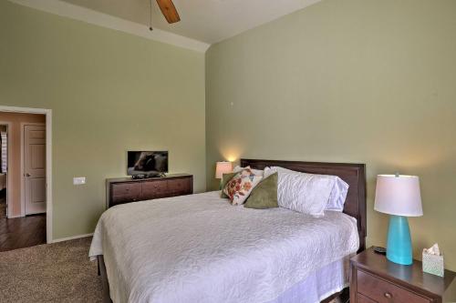 a bedroom with a large bed with white sheets and pillows at Tucson Getaway with Yard, Pool, Hot Tub and Gas Grill! in Tucson