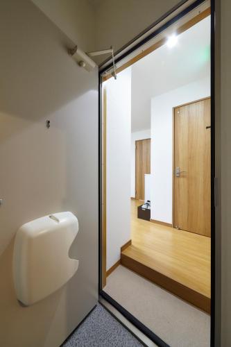 a sliding glass door leading into a room with a hallway at おやど紀伊国屋本石灰町 in Nagasaki