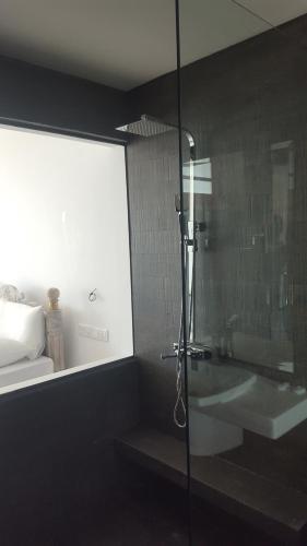 a bathroom with a shower and a bath tub at Naomi Beach Resort - Adults only in Weligama