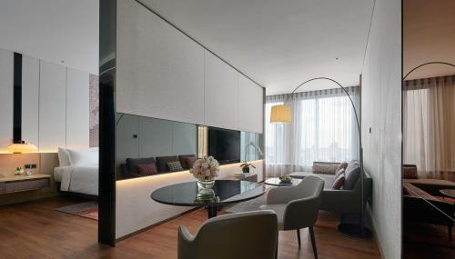 
a living room filled with furniture and a large window at EQ Kuala Lumpur in Kuala Lumpur
