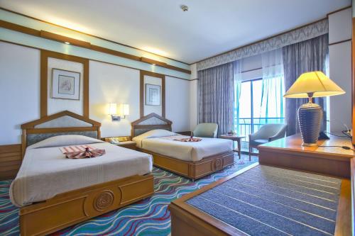 Tempat tidur dalam kamar di Asia Cha-am Hotel