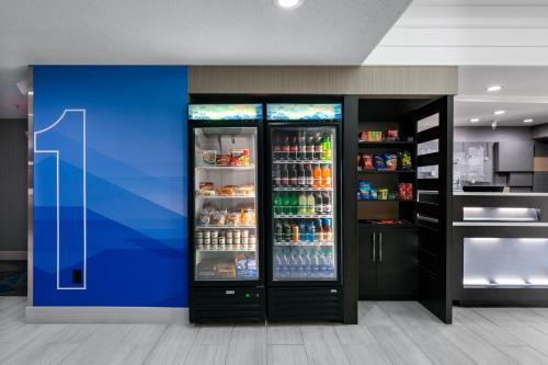 a large refrigerator filled with lots of drinks at Holiday Inn Express & Suites Milton East I-10 by IHG in Milton