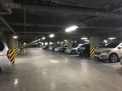 a parking garage filled with lots of parked cars at Incheon Airport Guesthouse in Incheon
