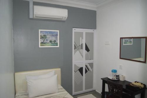 a bedroom with a bed and a wall at HOTEL SHAFURA 2 in Cukai
