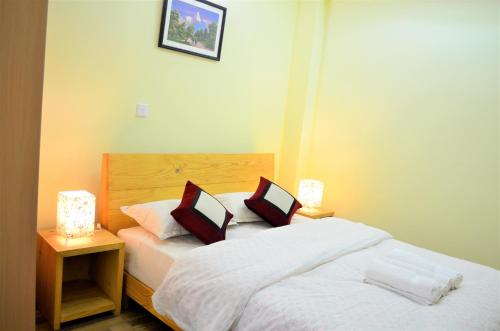 um quarto com uma cama com duas almofadas em Tanani Newa Home Arnnapurna em Patan