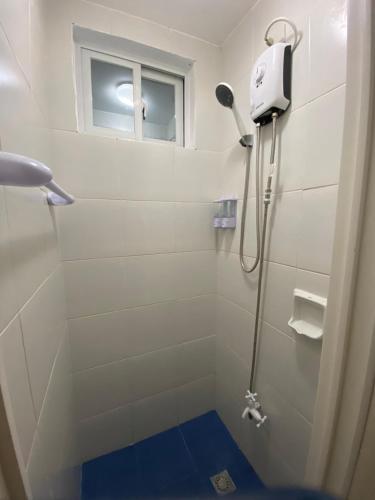 a shower in a bathroom with a window at Azul Zambales Beachfront House & River Cottages EXCLUSIVE in Cabangan