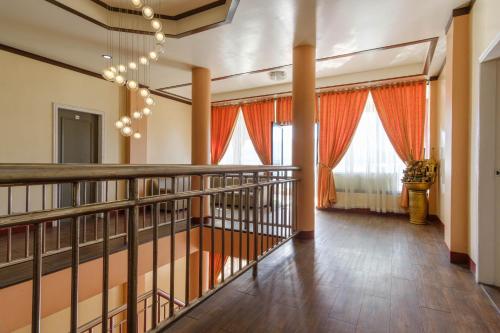 a hallway with orange curtains and a staircase at RedDoorz Plus @ Seaborne Hotel Subic Zambales in Subic