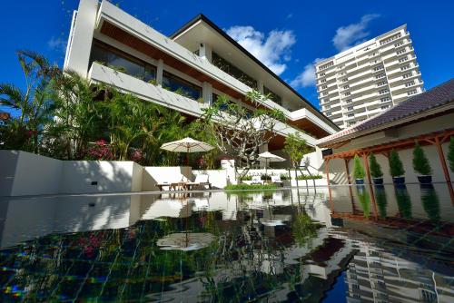 uma casa com piscina ao lado de um edifício em The Naha Terrace em Naha