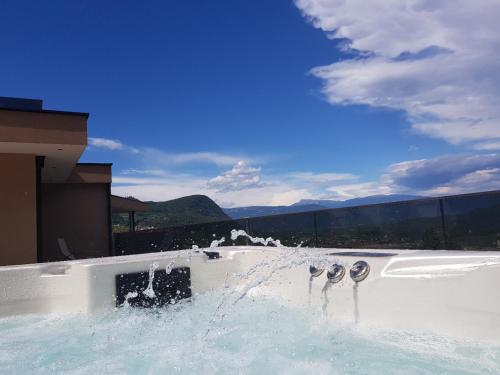 a hot tub with water spraying out of it at Aparthotel Malga in Caldaro