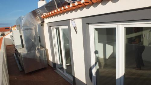 a balcony of a house with sliding glass doors at Hotel Baleal Spot in Baleal