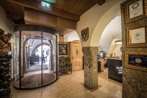 
a large room with a stone wall and wooden floors at BEST WESTERN Plus Hotel Goldener Adler Innsbruck in Innsbruck
