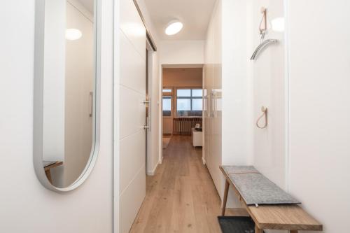 a hallway with a table and a mirror at Haus Dünenbake, Ferienwohnung Strandpeter Meerblick (Wohnung 47) in Sankt Peter-Ording