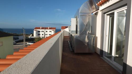 a balcony of a building with a view of the ocean at Hotel Baleal Spot in Baleal