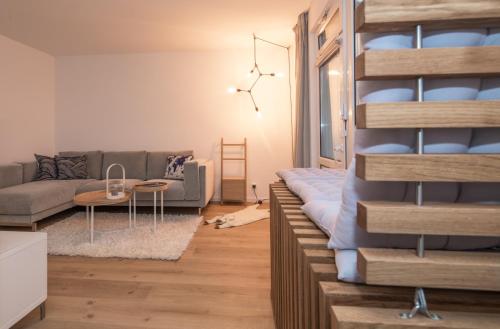 a living room with a couch and a table at Haus Dünenbake, Ferienwohnung Strandpeter Meerblick (Wohnung 47) in Sankt Peter-Ording