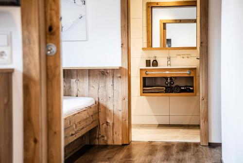 a small bathroom with a sink and a mirror at Allmi Appartement in Sankt Gallenkirch