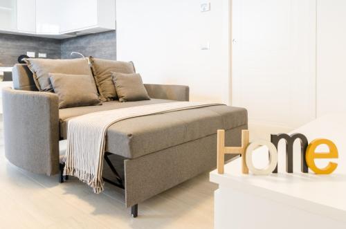 a couch and a chair in a room at Fco Secrets Luxury Apartment in Fiumicino