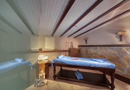 a bedroom with two beds and a stone wall at Sealife Family Resort Hotel in Antalya