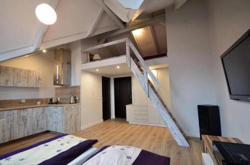 a room with a loft bed and a kitchen at Apartamenty ZACISZE in Koszalin