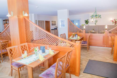a dining room with wooden tables and chairs at Waldhotel Friedrichroda in Friedrichroda