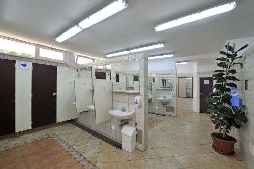 a large bathroom with two sinks and two toilets at Caravans Bijela Uvala in Poreč