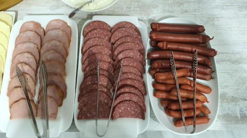 a group of sausages and other meats on plates at Mestia 4 season in Mestia