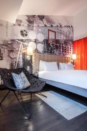 a bedroom with a large bed and a chair at Radisson Blu Riverside Hotel in Gothenburg