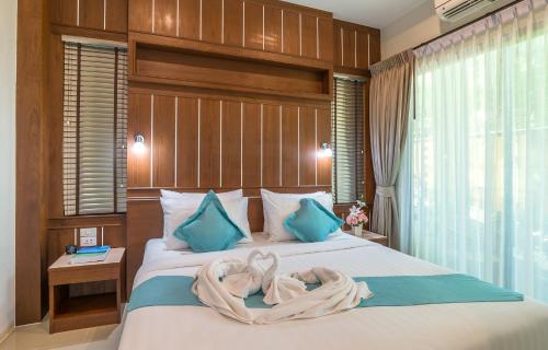 a bedroom with a bed with two towels on it at The Scene Cliff View Villas in Ao Nang Beach