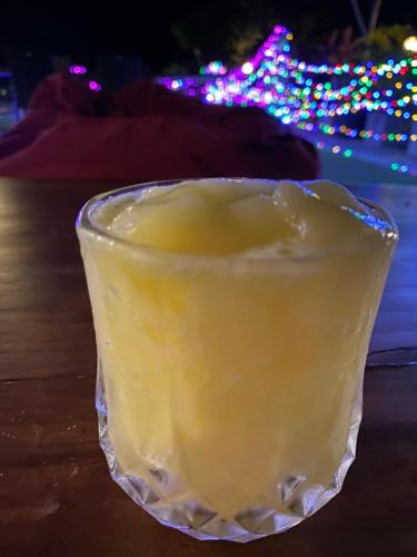 a drink in a glass on a table with christmas lights at The Scene Cliff View Villas in Ao Nang Beach
