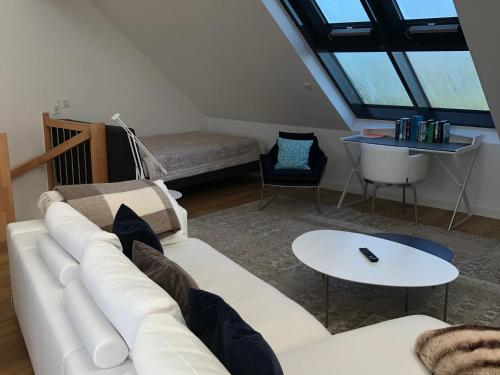 a living room with a white couch and a table at Tor zum Meer in Helgoland