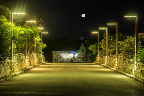 an empty road at night with street lights at One ON Marlin Resort in Turtle Cove