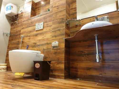 a bathroom with a toilet and a sink at Hotel Temple On Ganges in Varanasi