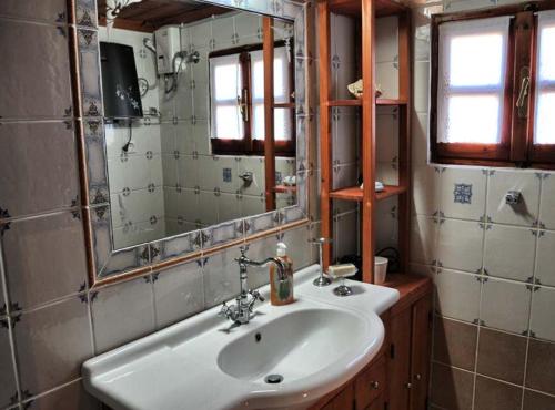 a bathroom with a sink and a mirror at Villas De Luna in Sidhirokhórion