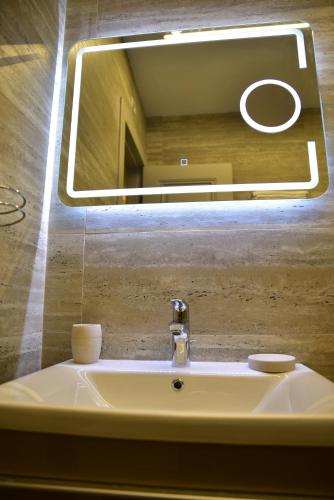 a bathroom sink with a mirror above it at The King Resort in Tirana