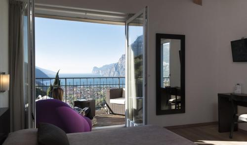 a room with a large glass door with a view at Hotel Isola Verde in Nago-Torbole